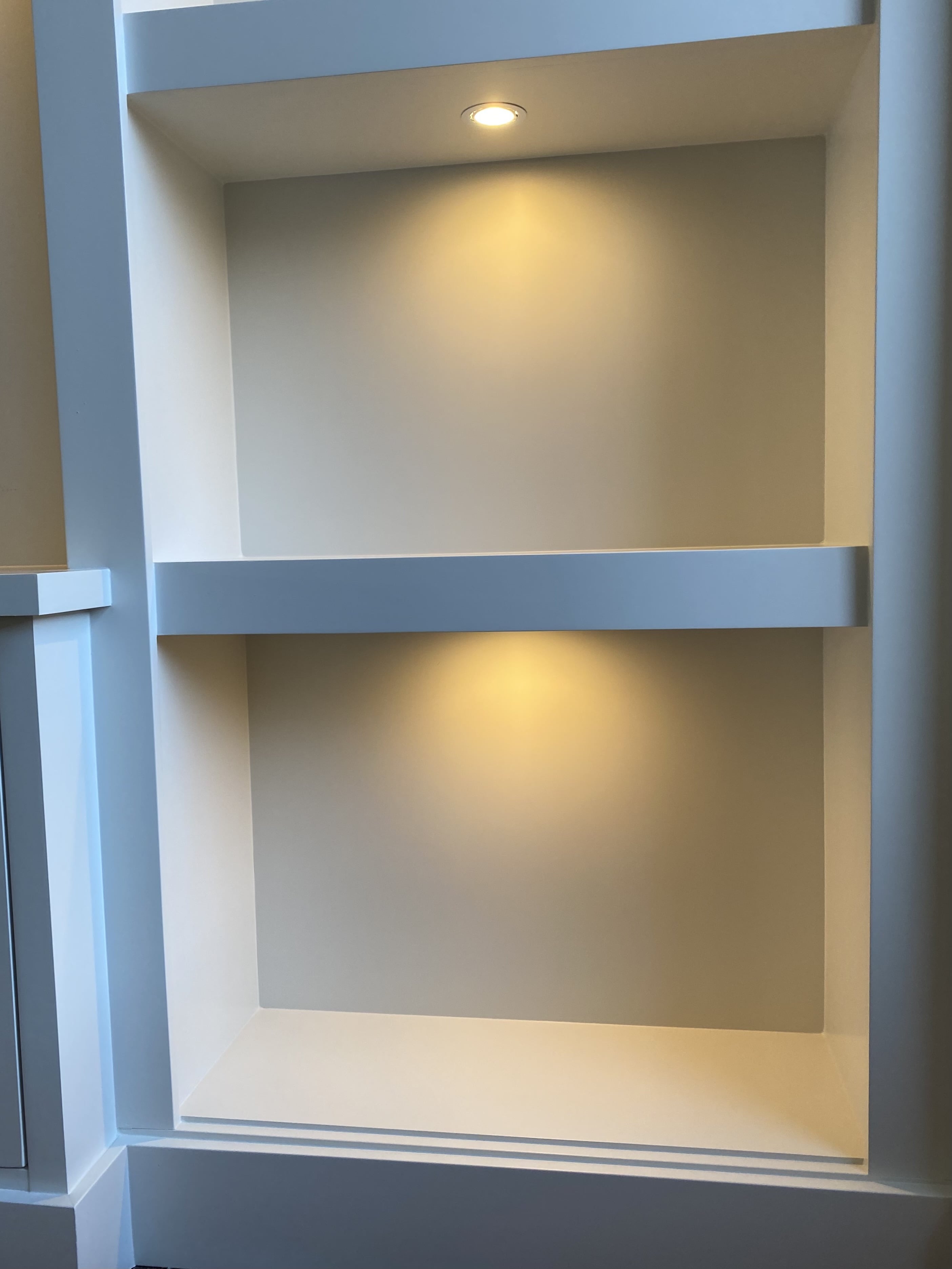 The shelves have dimmable LED puck lights to set the mood.